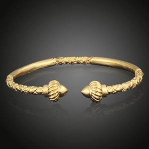 Detailed macro view of 18K gold-plated open bangle with vintage woven texture and spiral ends