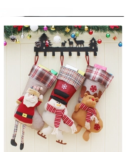Detailed view of burlap Christmas stockings featuring 3D Santa, Snowman and Reindeer applique
