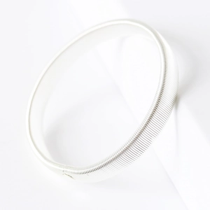 Adjustable silver metal spring coil armlet bracelet on a clean white background