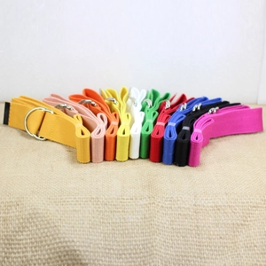 Multi-color canvas belts with silver double D-ring buckles on a rustic fabric background