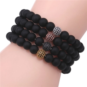 Set of four matte black beaded bracelets with gold, silver, and rose gold zircon charms