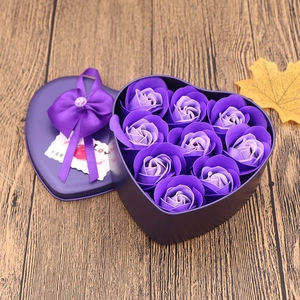 Macro shot of 9 purple soap roses in a heart-shaped tin with a silk bow and Love card