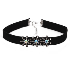 Detail of black velvet choker featuring snowflake charms with iridescent rhinestones