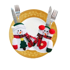 Christmas snowman cutlery holder set with heart and tree decor on a gold plate
