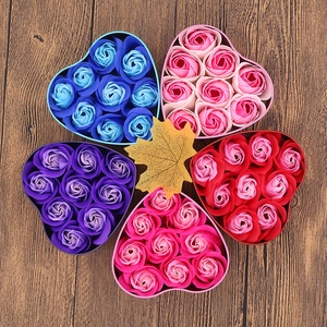 Detailed top view of five colorful heart-shaped tin boxes with 11 soap flower roses inside