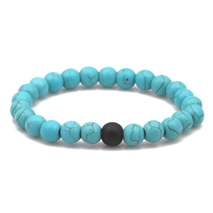 Detailed view of 8mm blue turquoise beaded bracelet with single matte black accent stone
