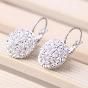 316L stainless steel hoop earrings with sparkling white crystals on a bamboo background