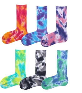 Flat lay of six pairs of cotton tie-dye mid-calf socks in vibrant gradient colorways