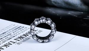 Macro shot of punk style stainless steel skull ring with vintage oxidized finish details