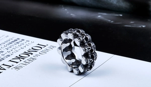 Macro view of punk stainless steel skull ring with vintage black industrial finish