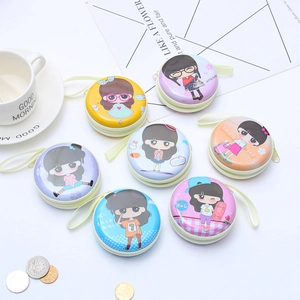 Flat lay of colorful tinplate round coin purses with cartoon girl motifs and wrist straps