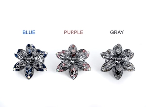 Detailed set of three floral crystal hair claws in blue, purple, and gray colors