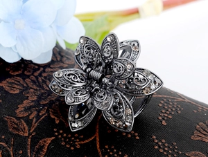Macro shot of antique silver flower hair claw clip with sparkling grey rhinestones