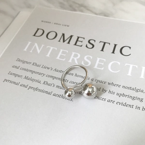 Minimalist S925 silver ring featuring asymmetrical double beads on a marble surface