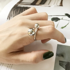 Minimalist S925 sterling silver open ring with double ball design worn on finger