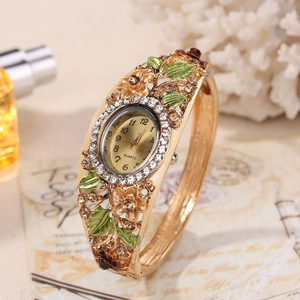 Detail of golden cloisonne floral bangle watch with green enamel and crystal accents