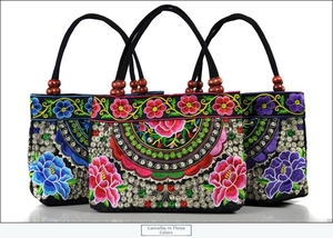 Detailed embroidery of camellia flowers on ethnic canvas handbags with wooden beads