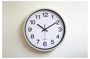 Detail of 12-inch wall clock with black Arabic numerals and precision quartz movement