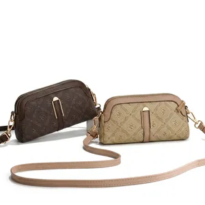 Detail view of mini printed crossbody bag with vintage monogram and adjustable strap