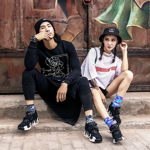 Street style couple wearing cotton tie-dye mid-calf socks and oversized graphic apparel
