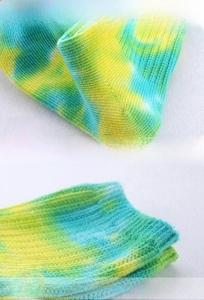 Detailed macro view of tie-dye knit socks showing reinforced heel and elastic cuff texture