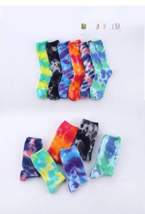 Close-up of vibrant tie-dye crew socks in various colorful patterns and thick knit texture
