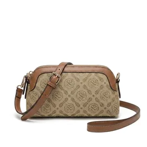 Detail view of stylish beige monogram crossbody bag with gold zipper and thin strap