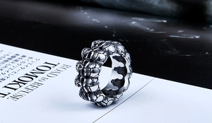 Detailed macro view of vintage punk skull ring in oxidized black stainless steel