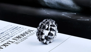 Detailed macro shot of vintage punk skull ring with embossed gothic metal carvings