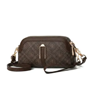 Detail view of brown monogram crossbody bag showing 21x11x5cm size and PU texture