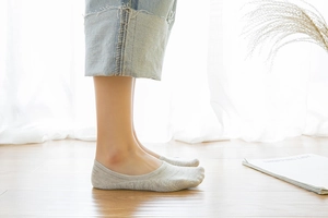 Close-up of light grey cotton invisible socks for women with anti-slip silicone heel detail