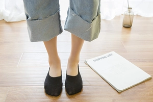 Close-up of black low-cut cotton liner socks with non-slip silicone heel grip for women