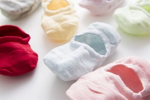 Close-up of pastel cotton no-show socks in various colors with seamless knit texture