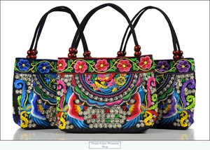 Detailed embroidery on canvas handbags featuring floral phoenix motifs and wood beads