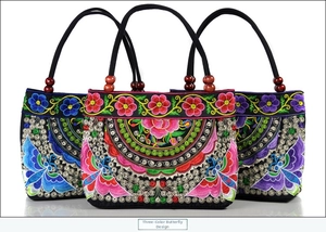 Detailed embroidery view of ethnic canvas handbags featuring butterflies and wooden beads