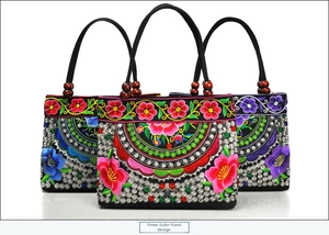 Three embroidered canvas tote bags with ethnic floral patterns and wooden bead handles