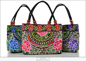 Detailed embroidery of pomegranate flowers and wooden beads on canvas ethnic handbags