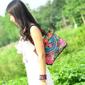 Ethnic style embroidered canvas handbag with floral patterns and wooden beads detail