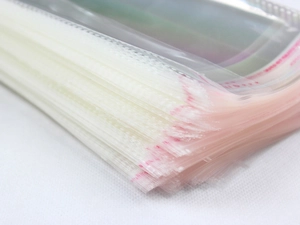 Macro shot of thin transparent OPP self-adhesive bags for socks and textile packaging