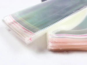 Macro detail of transparent plastic self-sealing bags with red seal strip for packaging