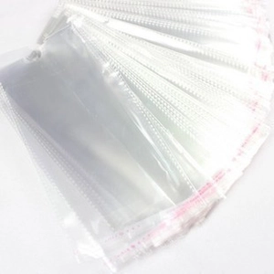 Stack of clear self-adhesive plastic bags for packaging socks with red sealing strip