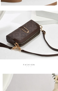 Detailed view of the double zipper and vintage logo pattern on the brown crossbody bag