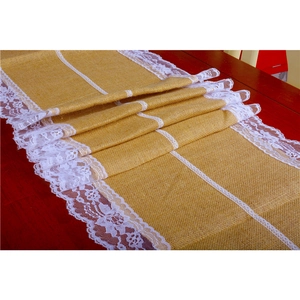 Detailed close-up of natural jute table runner with delicate white lace edge decoration