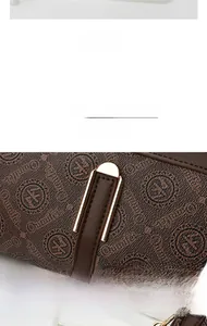 Detail of brown leather bag with monogram pattern and electroplated gold metal hardware