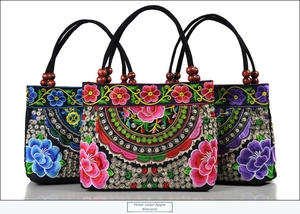 Detailed embroidery of apple blossoms on three ethnic canvas handbags with wooden beads