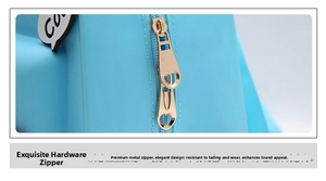 Close-up of golden heart-shaped zipper pull on a light blue silicone backpack