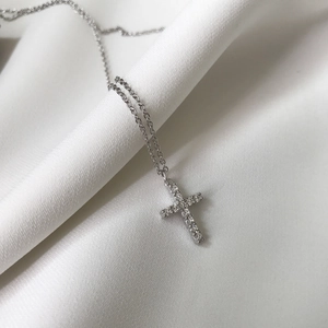 Elegant 925 sterling silver cross necklace with sparkling zircon pave on white silk fabric