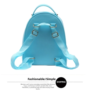 Detail of light blue silicone backpack featuring adjustable straps and gold metal buckles