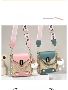Detailed view of structured crossbody bags featuring logo prints and plush charms