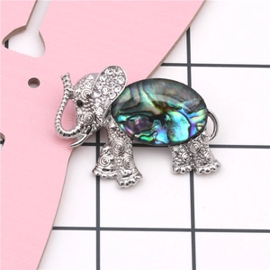 Macro detail of elephant brooch featuring abalone shell inlay and sparkling rhinestones